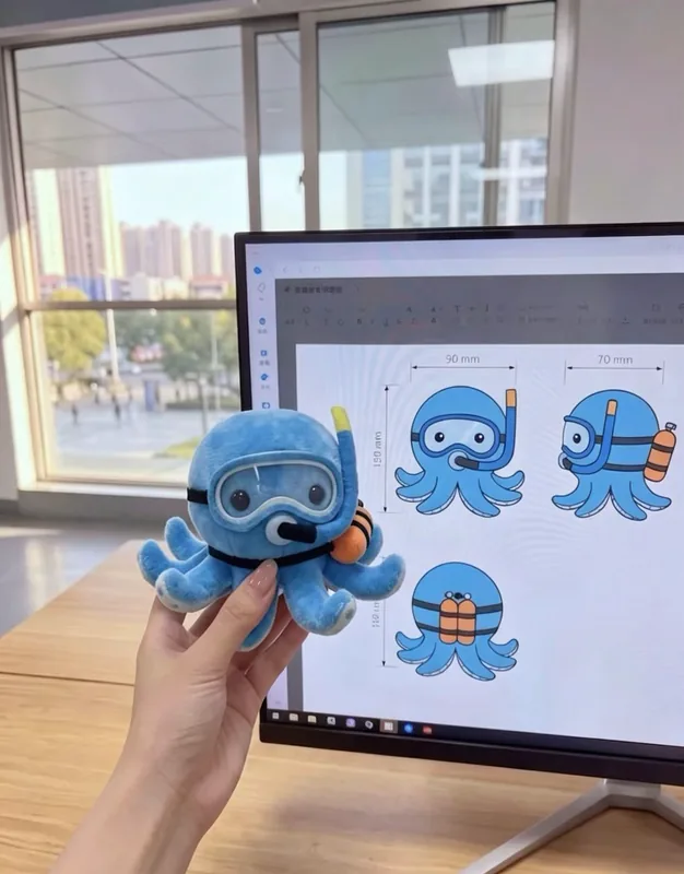 Une pieuvre en peluche bleue avec un masque de plongée, à côté du dessin du personnage sur un écran.